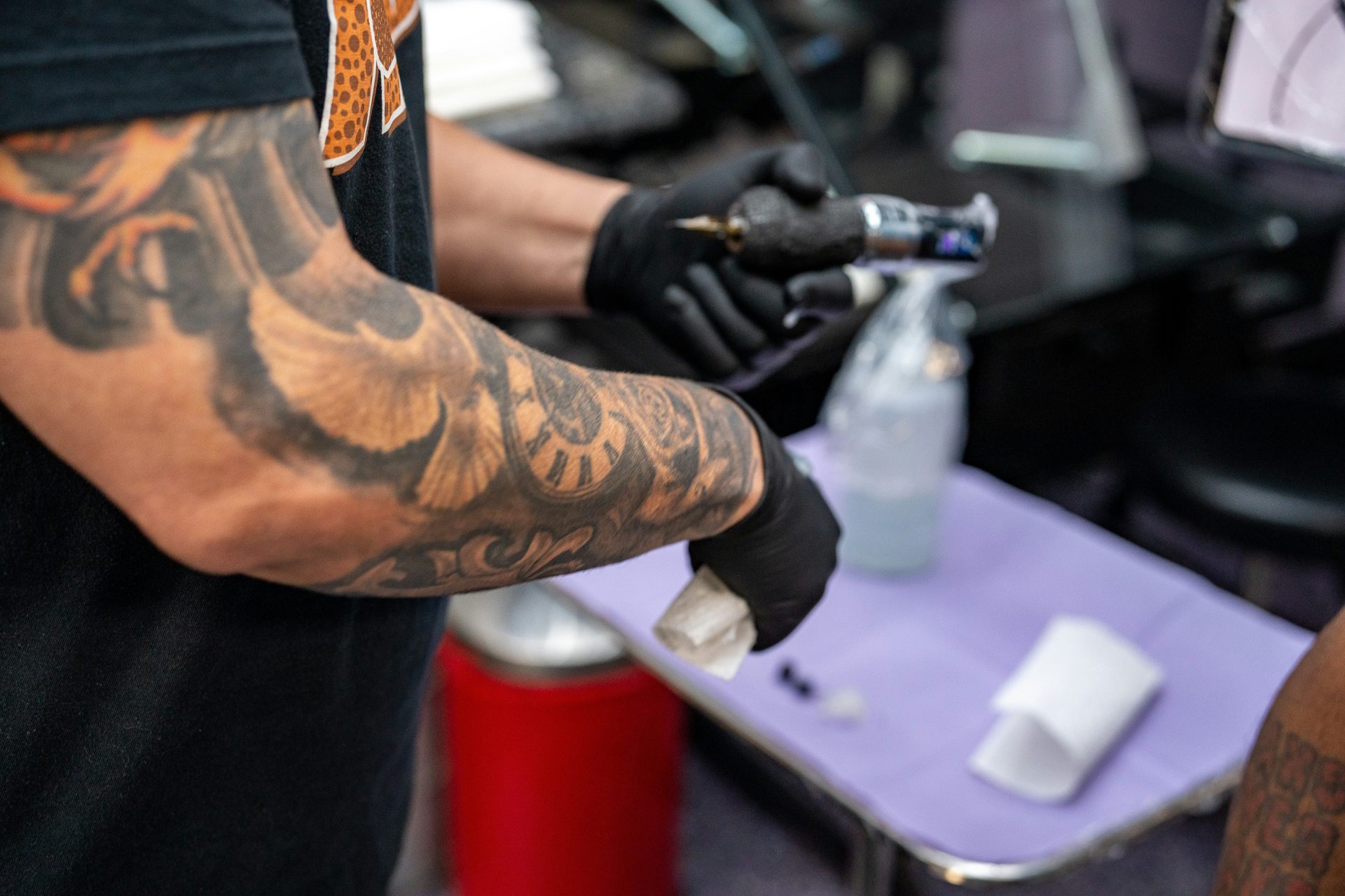 Tattoo artist preparing equipment for new tattoo